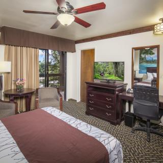 Best Western Plus Yosemite Gateway Inn | Oakhurst, California | Queen bed with desk, dresser, seating area and TV