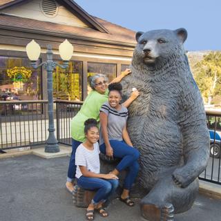 Best Western Plus Yosemite Gateway Inn | Oakhurst, California | Family sitting on bear statue