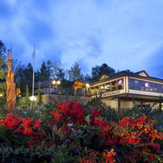 Best Western Plus Yosemite Gateway Inn | Oakhurst, California | Outdoor view of hotel restaurant with red flowers